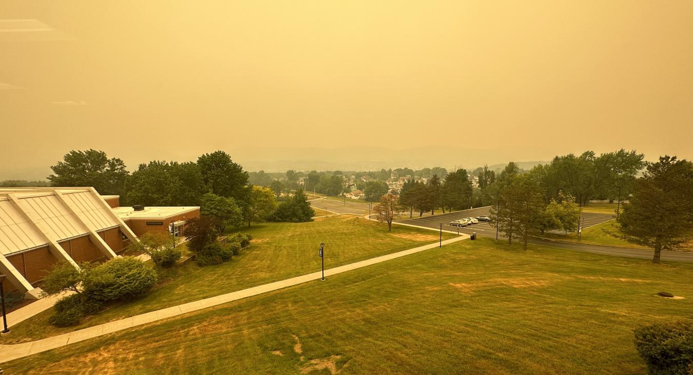 A lawn on the scranton campus with a smokey mountain backdrop 